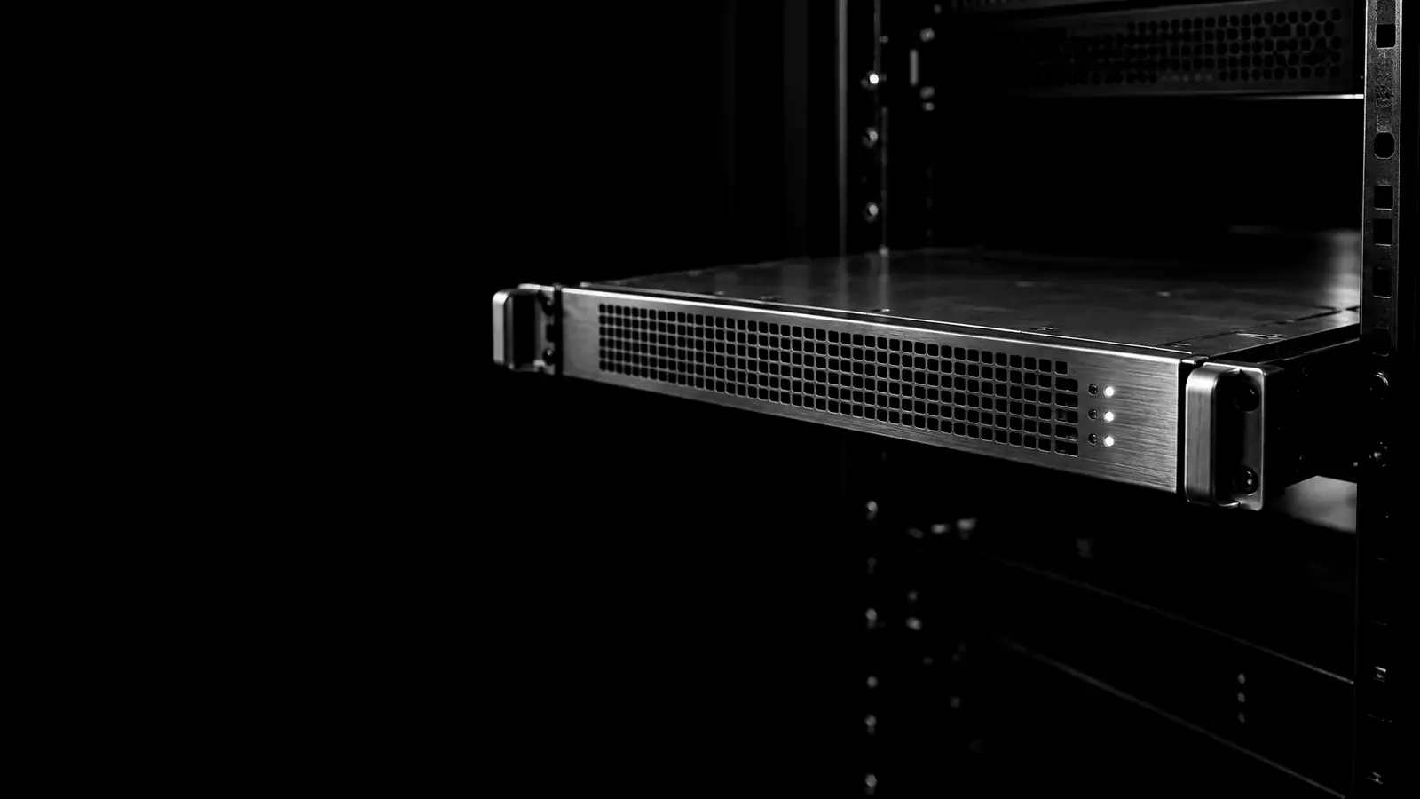 A server sliding into a rack in a dark data center