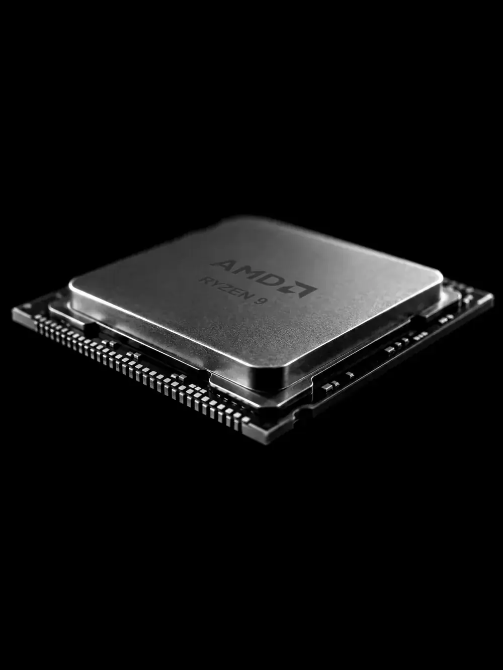 An AMD Ryzen 9 processor lit from the side against black